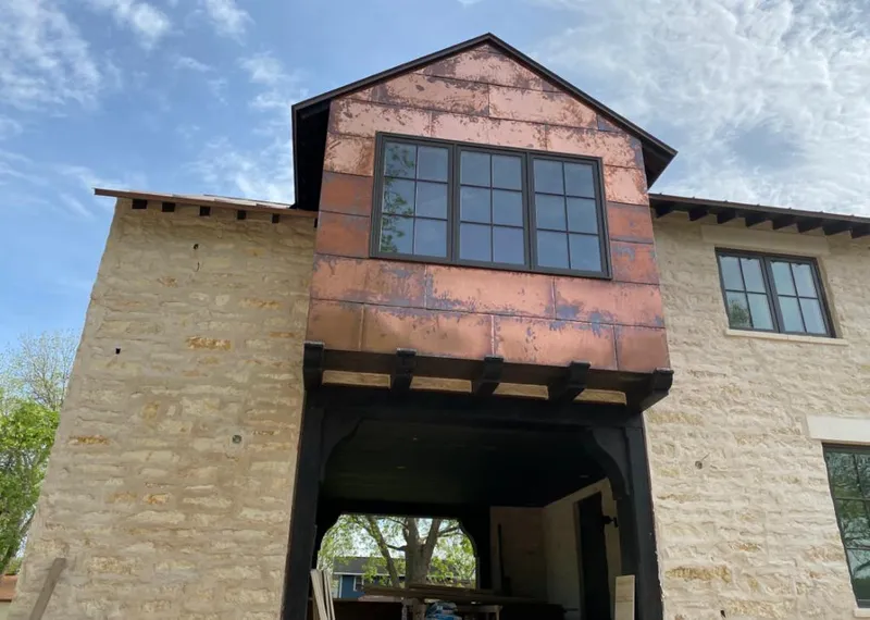 Copper metal panel facade on a stone building for Skylight Installation in Dos Palos